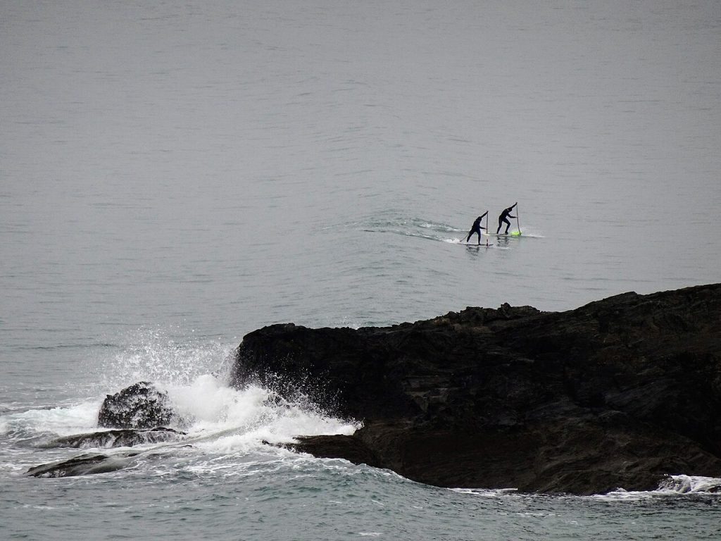 A rider surf foiling on a wave